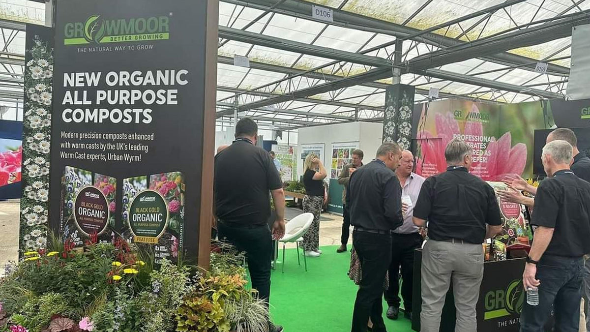 Gro Worm exhibition stand at the Four Oaks Trade Show with a New Organic All Purpose Composts banner and visitors browsing