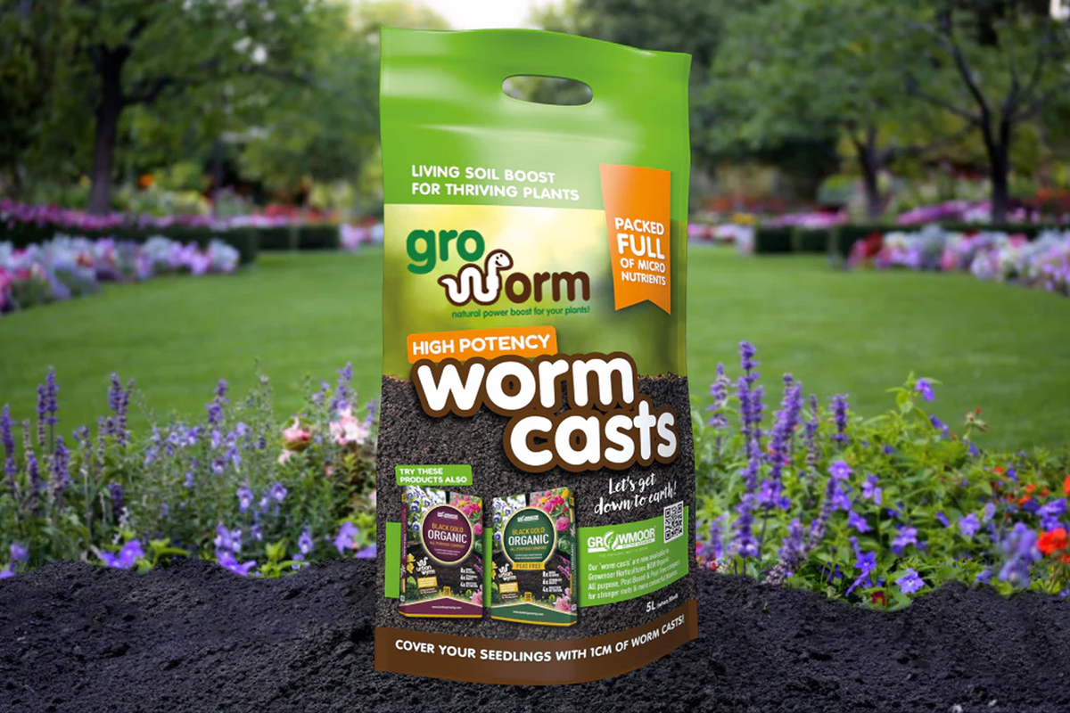Green Gro Worm Worm Casts 5-litre bag standing in a flower garden